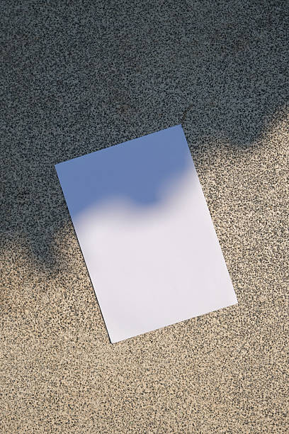 empty vertical paper poster mockup on concrete stone floor or pavement outdoors, shadow overlay