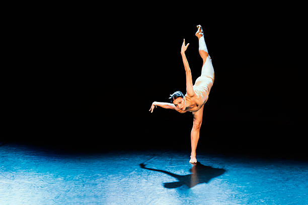 Ballet, dancing and woman artist at window for training, musical theatre or concert studio. Female ballerina, dancer and learning performance position of production, academy class or creative freedom