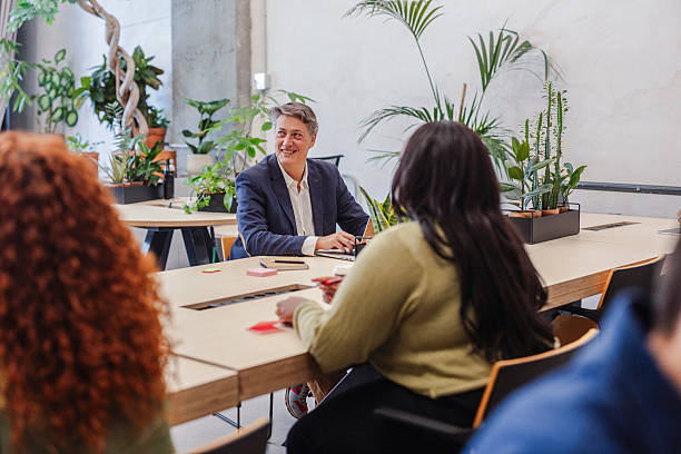 istock Manager leading a business meeting in modern green office 2214739110