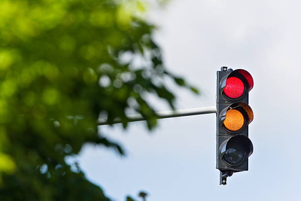 istock Stop red and orange light on traffic lights. Isolated on blue background. Negative copy space. 2214742058