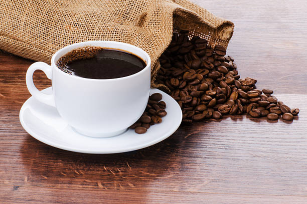 istock Coffee cup and beans on the wooden table 2214742791