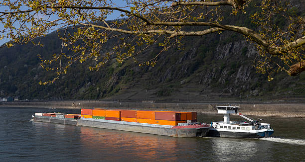 Container ships at The river Rhine near Kestert at Germany. Rhine Valley. Rhineland Palatinate