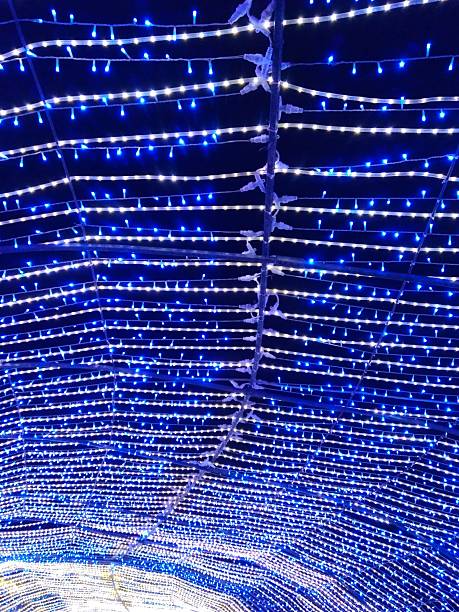 istock blue garlands on the night sky, glow, illumination, luminescent, blue, white, light bulbs, light, celebration, decoration, lighting 2214743937
