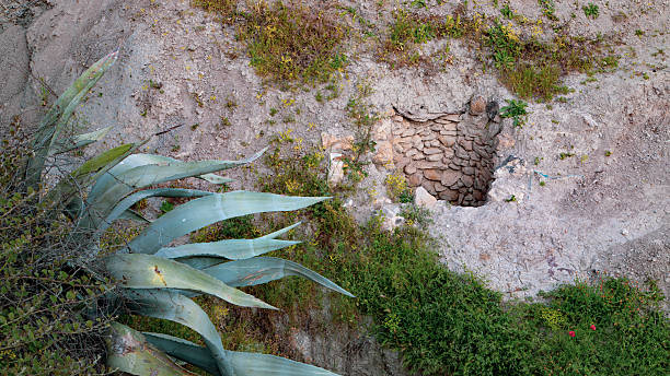 Walled stone opening on a dry Moroccan slope
