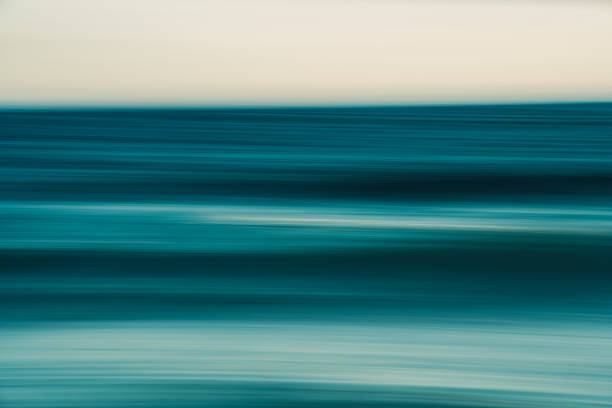 istock Blurred ocean horizon with teal and beige tones in motion. 2214748460