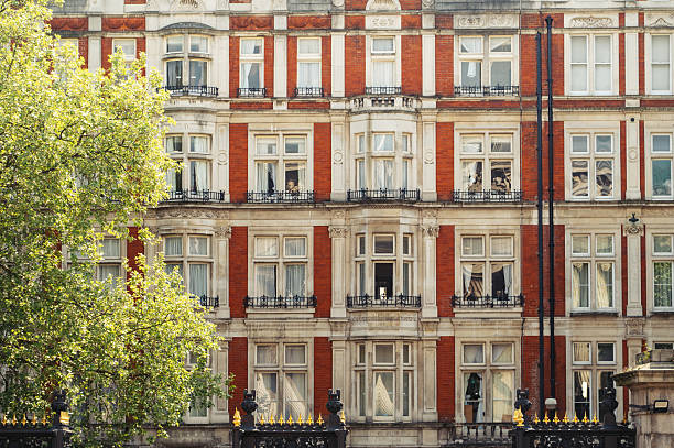 London, United Kingdom - March 24, 2014: Main façade of the Hotel Russell, a luxury hotel & event venue in the Bloomsbury neighborhood of Central London, owned and operated by the Principal Hayley Group. Built in 1898 by Charles Fritzroy Doll, it is distinctively clad in decorative thé-au-lait terracotta, based on the Château de Madrid on the Bois de Boulogne in Paris.