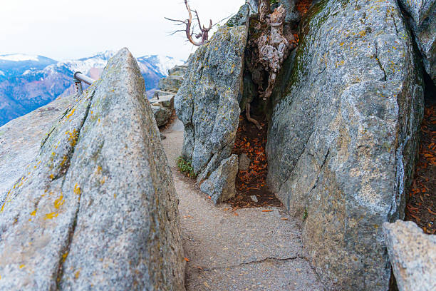 Close-up view of the rocky trail leading to Moro Rock, showcasing textured granite formations and surrounding mountain scenery in Sequoia National Park.