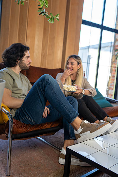 istock Happy Couple eating popcorns 2214751419