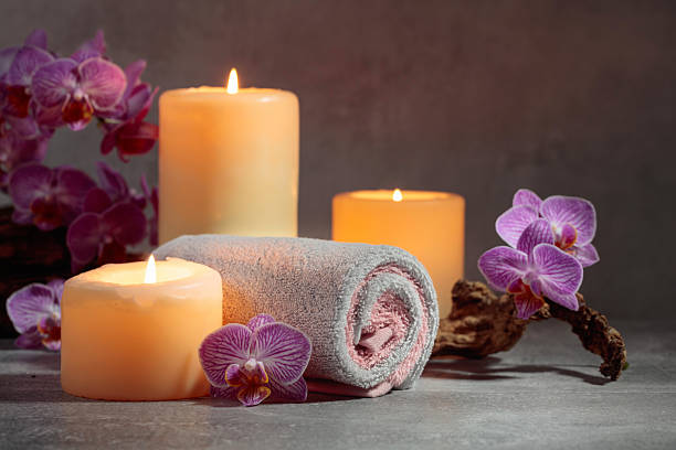 istock Towels, orchid flowers, and burning candles. 2214751920