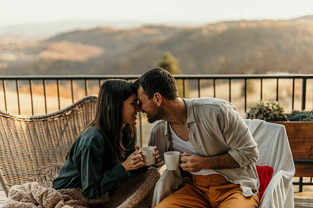istock Couple bonding over coffee on a balcony with a breathtaking view 2214752048