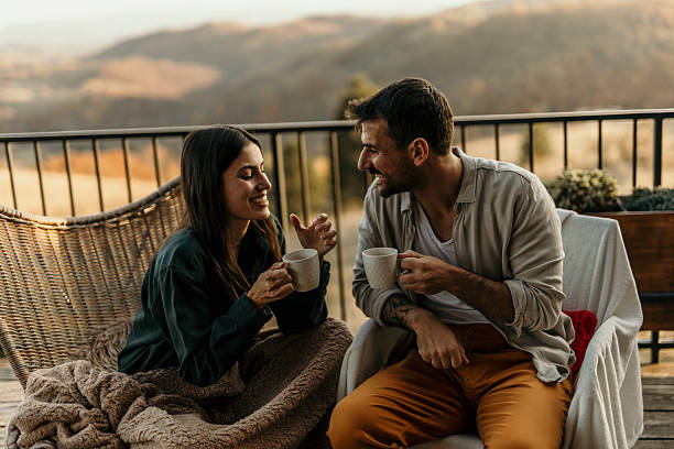 istock Couple enjoying a relaxing moment with coffee on a balcony overlooking hills 2214752101
