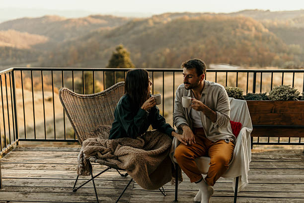 istock Couple enjoying coffee and scenic view on balcony at sunset 2214752235