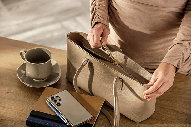 istock Woman Closing Handbag Before Work – Morning Office Preparation Scene. Getting to work and everyday and lifestyle activities concept. 2214752288