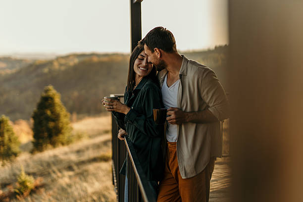 istock Romantic couple enjoying coffee and scenic view from balcony 2214752401