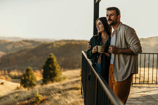 istock Couple enjoying a scenic view from their mountain cabin balcony 2214752418