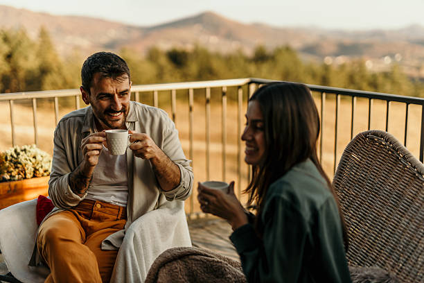 istock Couple enjoying a relaxing morning coffee on balcony with mountain view 2214752483