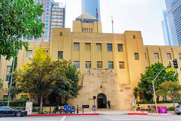 Los Angeles, California - December 4, 2024: Wide-angle view of the Los Angeles Central Library's facade, showcasing its architectural details and surrounding greenery on a sunny day.