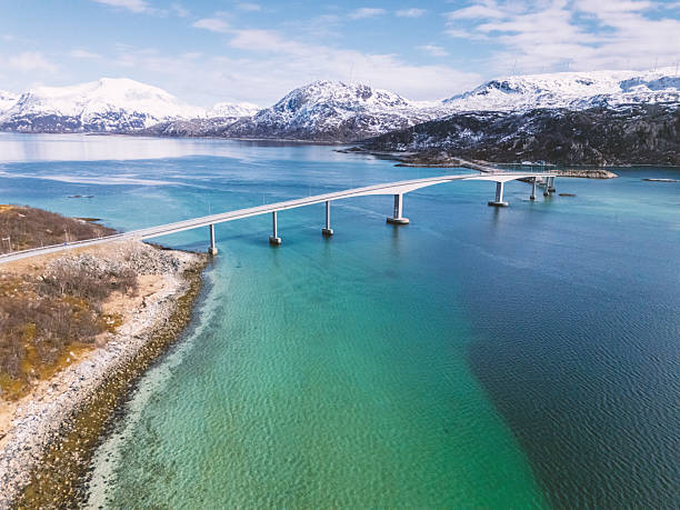 istock Scenic Bridge Over Pristine Fjord with Snow-Capped Mountains 2214753490