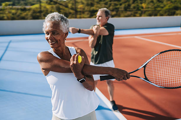 Senior people stretching to play tennis