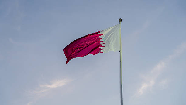 istock qatar flag flying high in the wind. 2214754852