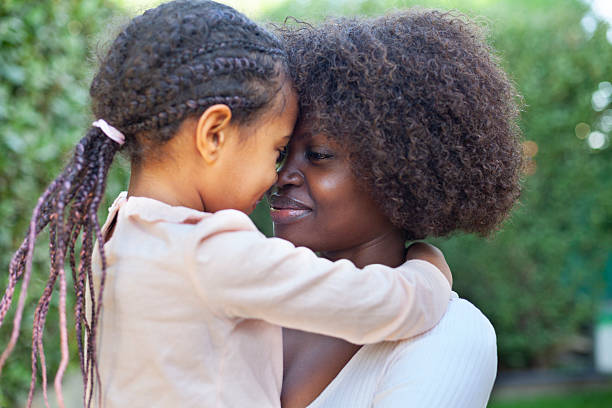 istock Spring portrait African mother embracing her child in backyard 2214756442
