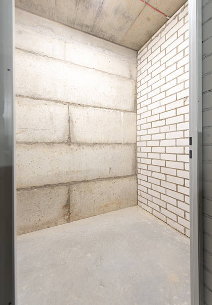 istock Minimal Interior Space Displaying Concrete and Brick Walls in Storage Room 2214756489