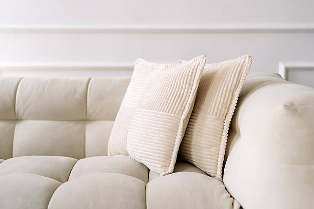Modern white couch with soft pillows in a stylish minimalist interior setting