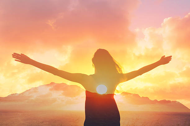 istock Happy joyful woman standing with her back on sunset in nature . 2214758814