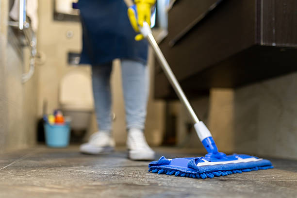 istock Person mopping a bathroom floor with a blue cleaning tool during daytime 2214758986