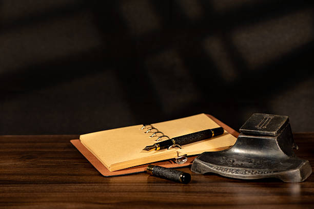 istock Fountain pen, beautiful fountain pen in an old environment with a black background, selective focus. 2214759528