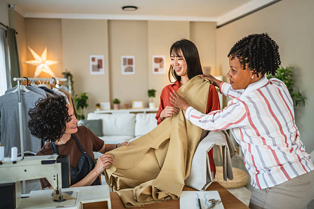istock tailor and consultant help costumer to find materials for dress 2214760220