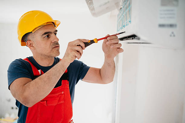Caucasian worker installs air conditioner