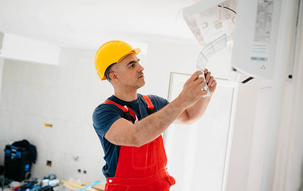 istock Caucasian worker installs air conditioner 2214763214