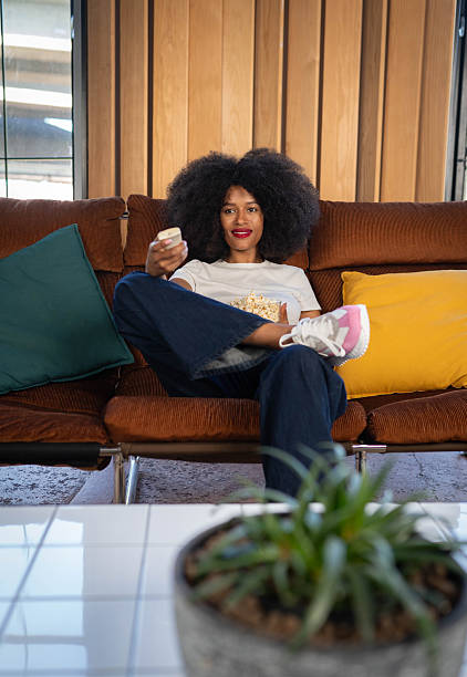 istock Woman eating popcorn and watching TV 2214764507