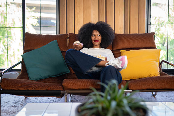 istock Woman eating popcorn and watching TV 2214764585