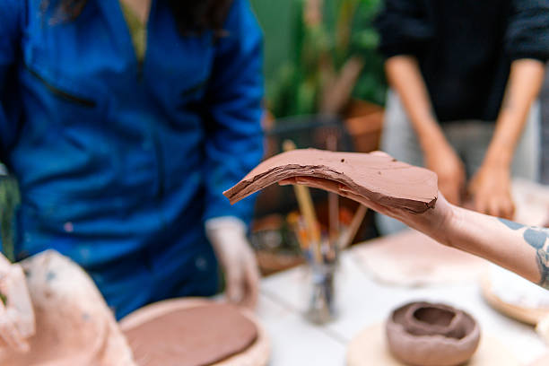 Potter showing piece of clay during pottery workshop