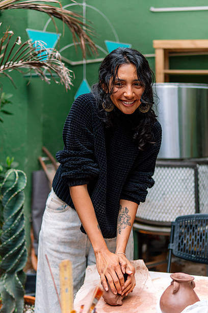 istock Latin woman creating pottery in a workshop 2214766650
