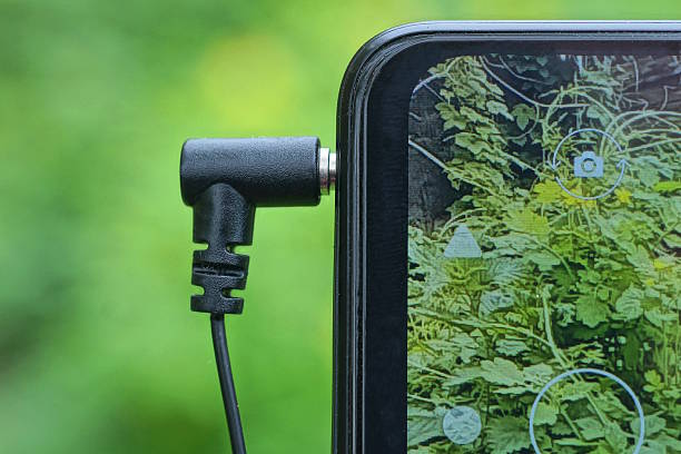 istock part of one smartphone with black plug and headphone wire 2214766705