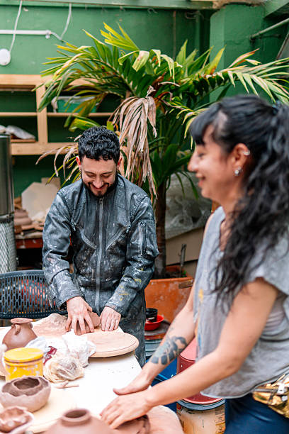 istock Two smiling ceramists kneading clay in pottery workshop 2214766753