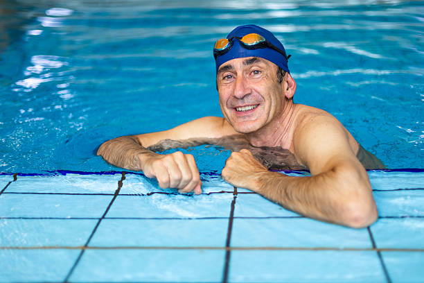 istock Senior man relaxing in swimming pool after exercising 2214767092