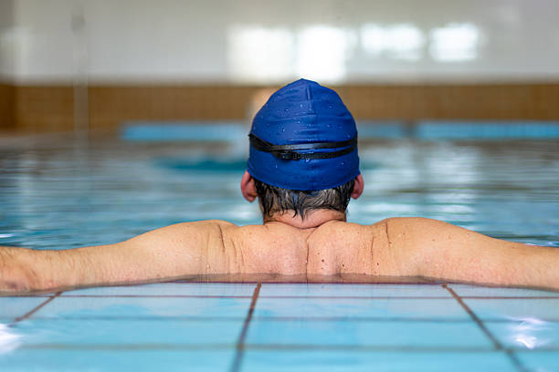 istock Swimmer relaxing in indoor swimming pool after training 2214767099