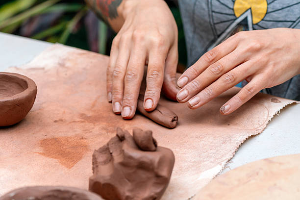 istock Potter molding clay on workbench creating handcrafted pottery 2214767339