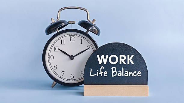 istock Alarm Clock with Table Sign Displaying Work Life Balance Representing Time Management, Wellbeing, and Healthy Lifestyle Choices 2214767538