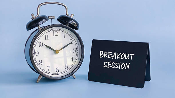 Alarm Clock with Table Sign Displaying Breakout Session Representing Scheduled Discussion, Time Management, and Group Collaboration