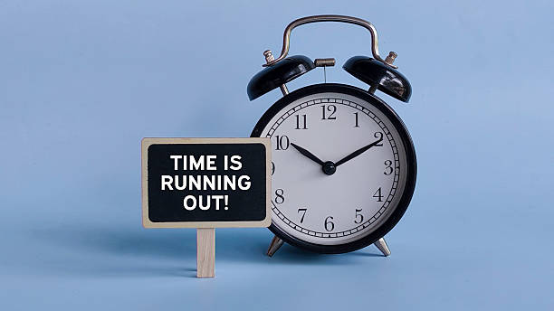 istock Alarm Clock with Table Sign Displaying Time Is Running Out! Representing Urgency, Deadline Pressure, and Last-Minute Alert 2214767543