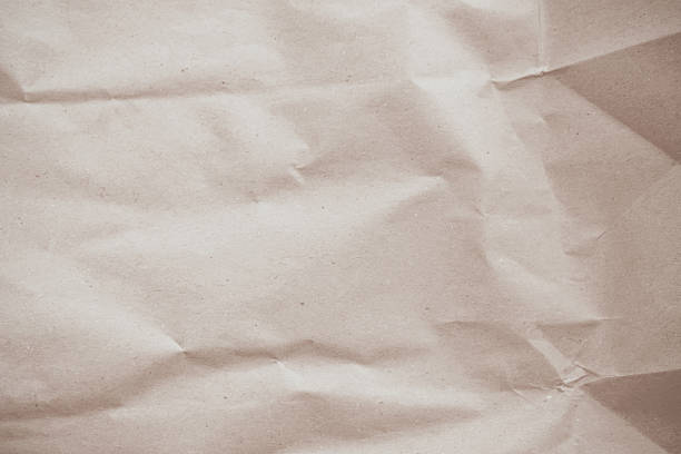 Old paper vintage texture surface for background. Recycle pale brown paper crumpled texture, Cream color recycled kraft paper texture blank with copy space for text.