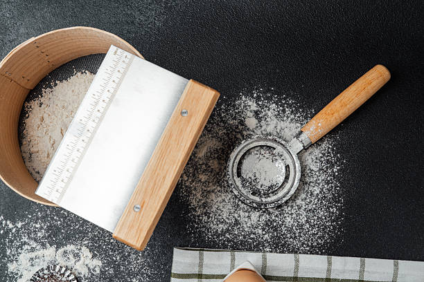 istock Baking preparation with flour and sifter on a dark kitchen countertop 2214772028