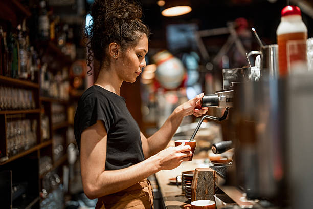 istock Skilled Aboriginal Barista Operating Professional Coffee Machine in Cozy Cafe 2214772529