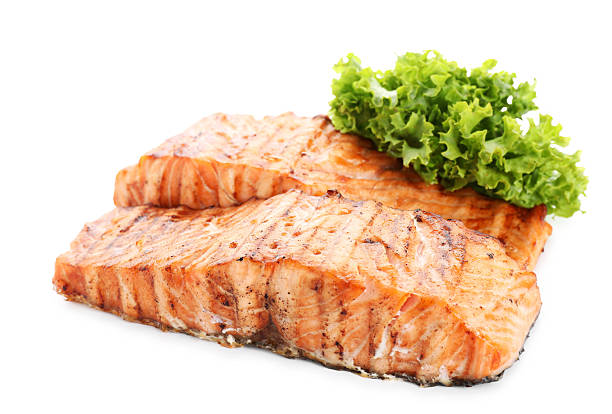 istock Delicious grilled salmon fillets with lettuce isolated on white 2214773648