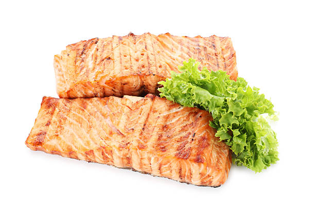 istock Delicious grilled salmon fillets with lettuce isolated on white 2214773681